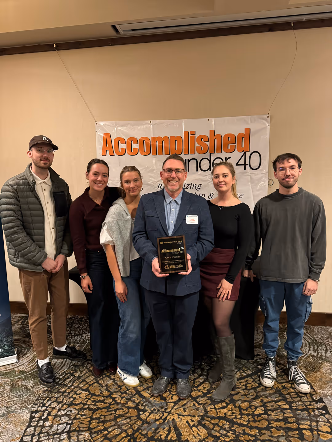 The team with an Accomplished Under 40 plaque
